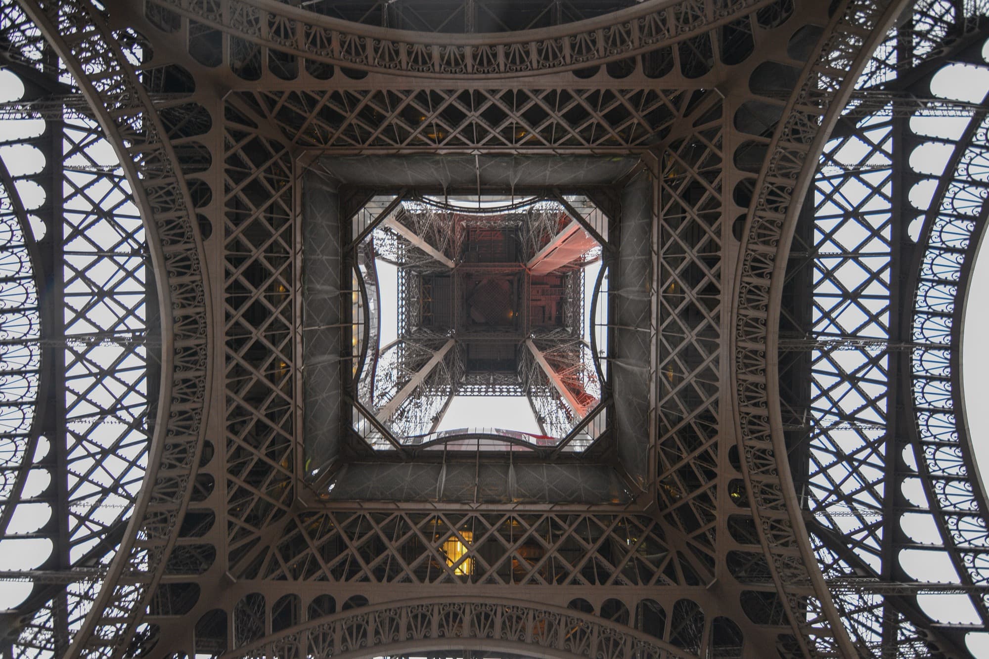 Looking up into the open iron lattice, which is mostly empty space, letting wind pass straight through. Photo by Jorge Láscar, CC BY 2.0.